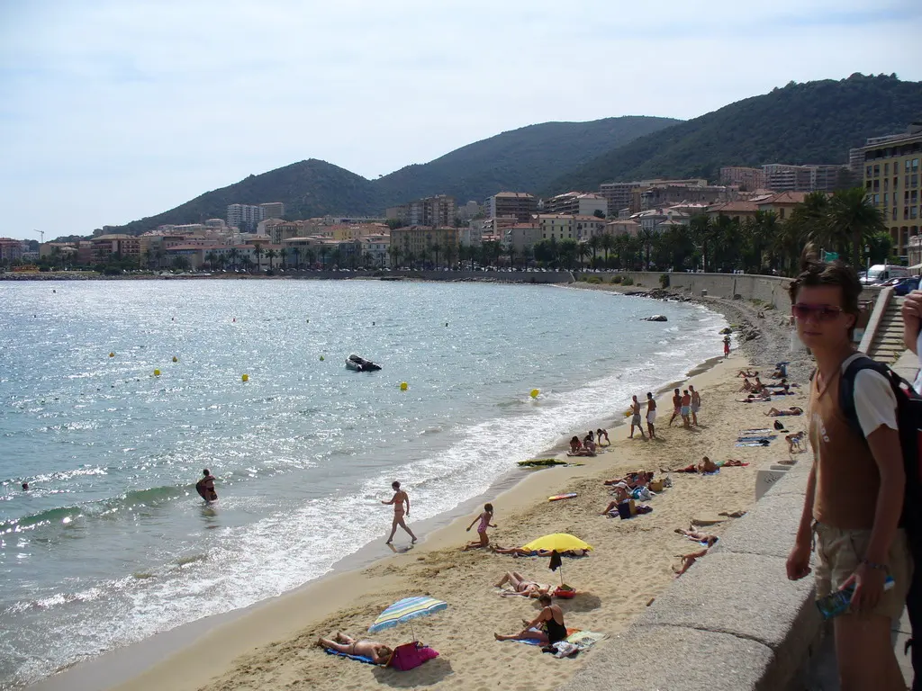 Plage Saint-Francoise, Ajaccio, Ajaccio, Corsica - town beach below the citadel with mountains behind the bay
