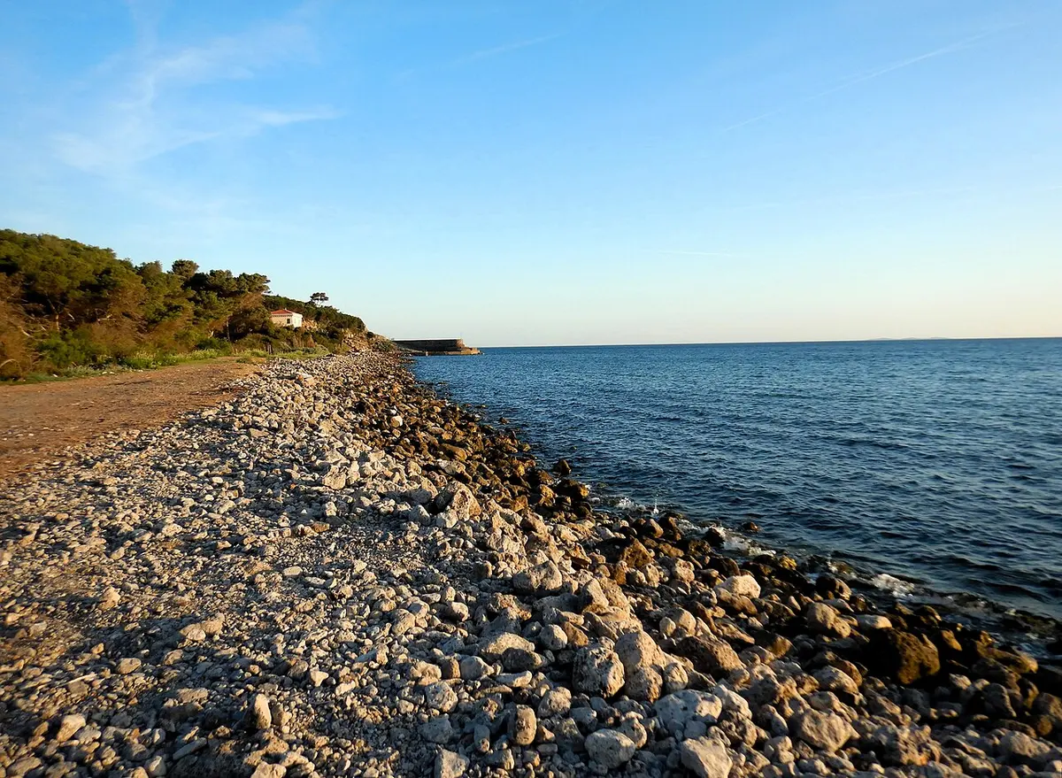 Ansedonia Beach, Tuscany, Ansedonia, Orbetello, Grosseto, Tuscany - wide sandy beach below roman ruins in southern tuscany