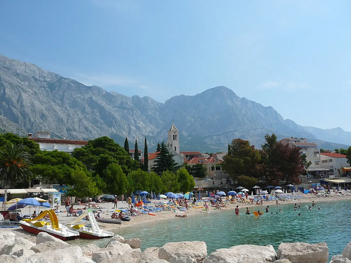 Baska Voda Beach, Baska Voda, Makarska Riviera - pebble beach in front of a church and the biokovo mountains