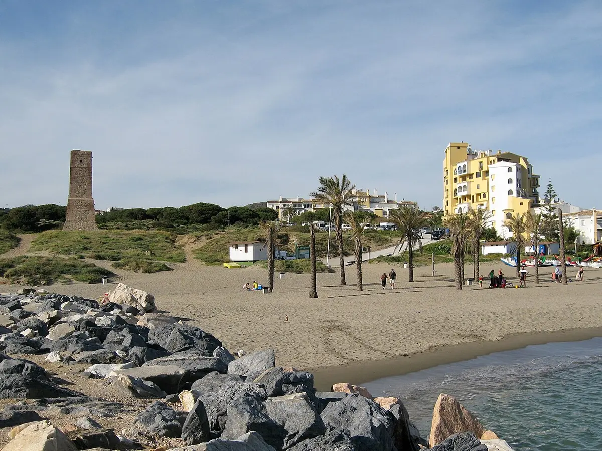 Playa de Cabopino, Marbella, Costa del Sol - sandy cove beside a marina and old watchtower