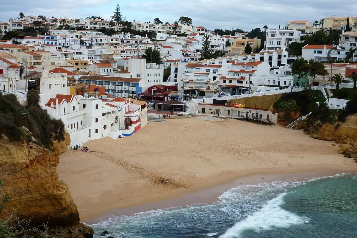 Praia do Carvoeiro, Lagoa, Algarve - small cove beach below a whitewashed algarve village