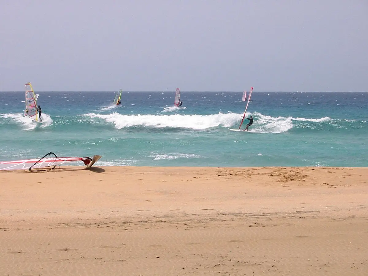 El Cotillo Beach, El Cotillo, Fuerteventura - windy sandy beach with turquoise water and windsurfers