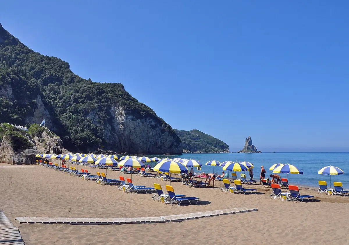 Agios Gordios Beach, Agios Gordios, Corfu, Ionian Islands - long blue flag beach beneath steep green cliffs