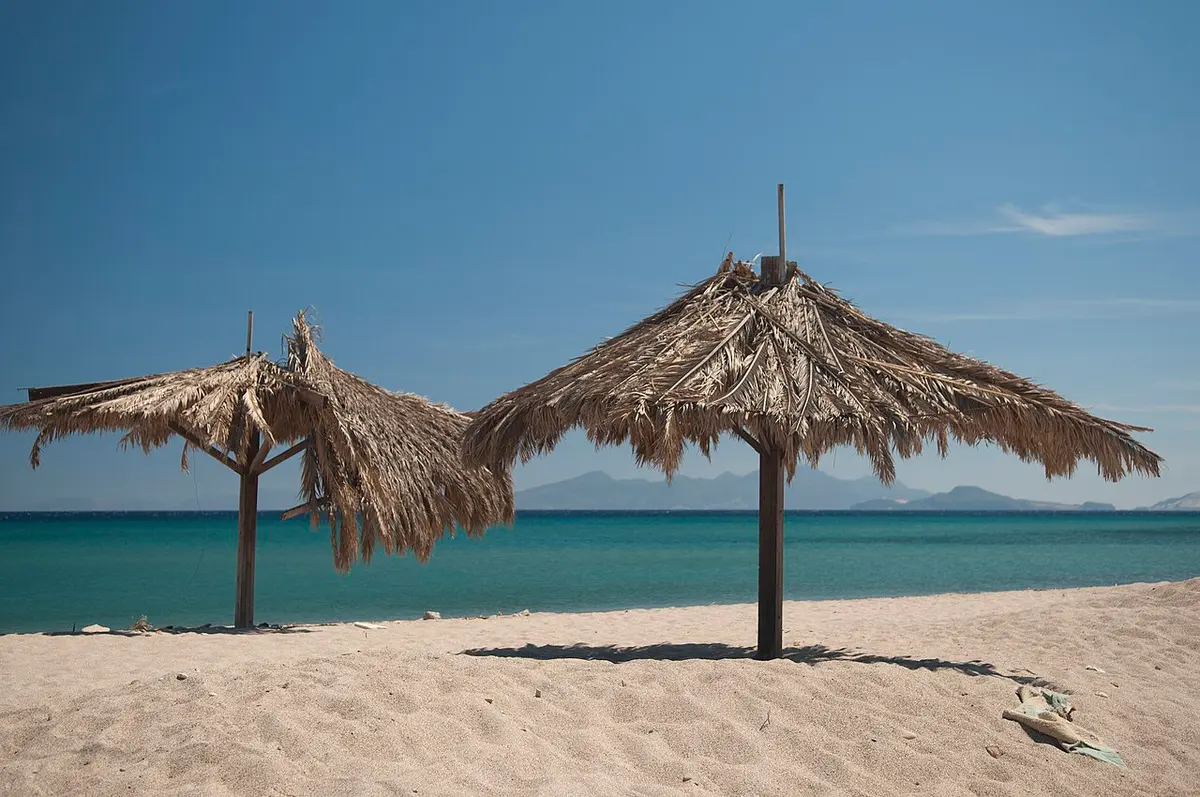 Kardamena Beach, Kos, Kardamena, Kos - long sand beach with thatched parasols