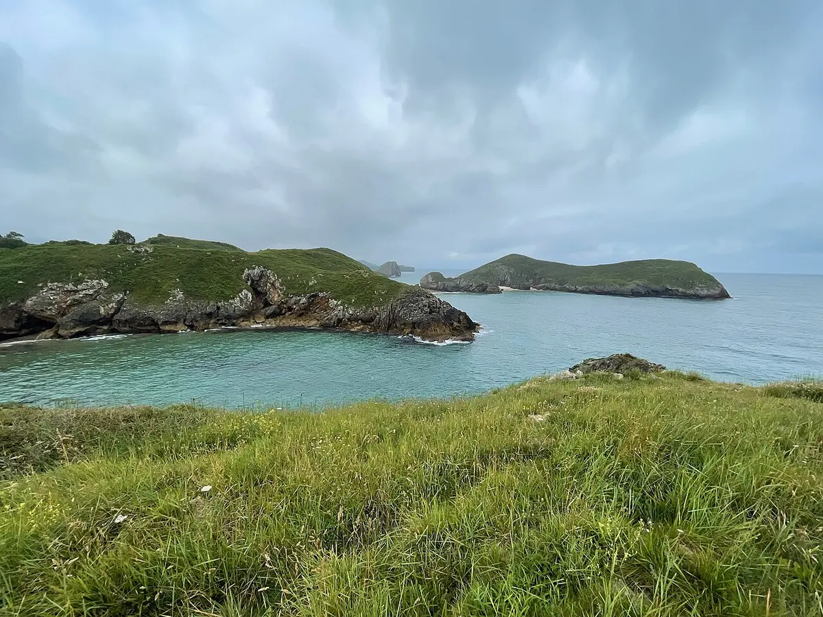 Playa de Poo, Llanes, Poo, Llanes, Asturias - small sandy cove between green cliffs on the asturian coast