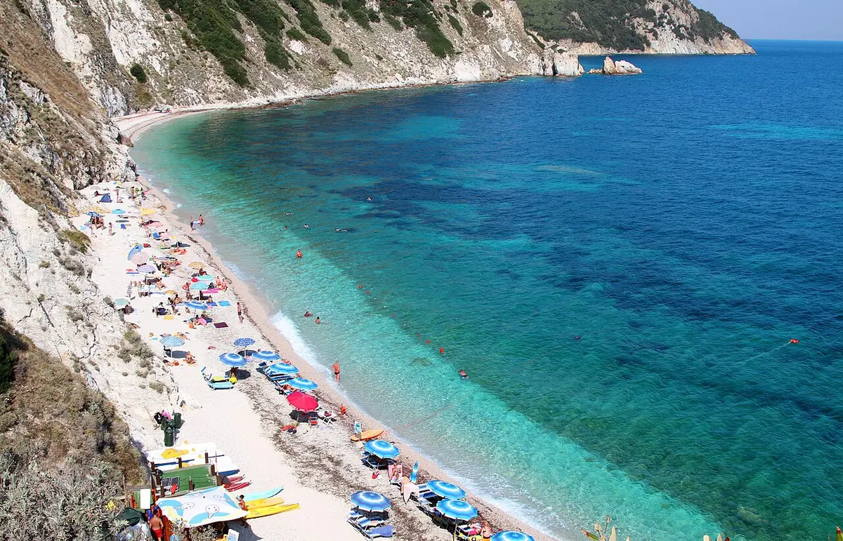 Sansone Beach, Portoferraio, Elba - white-pebble bay under green cliffs