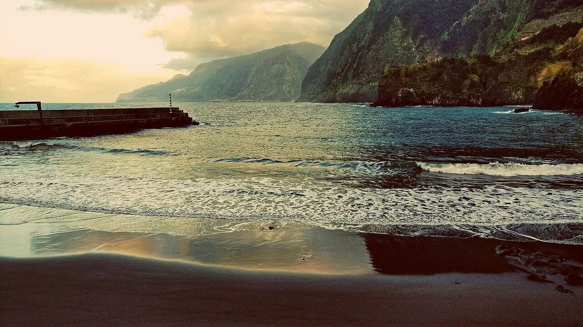 Praia do Seixal, Seixal, Madeira - black volcanic sand under green madeira cliffs